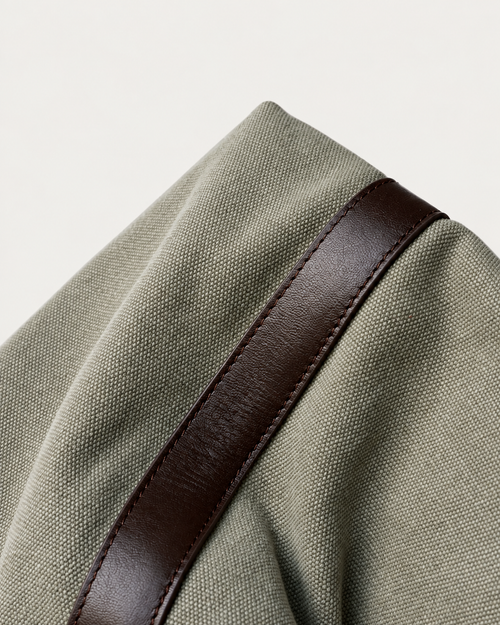 Canvas weave and brown leather trim detail